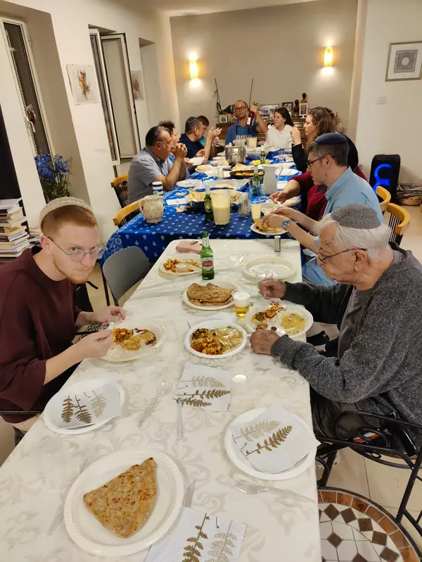 Guests enjoying dinner at a long table