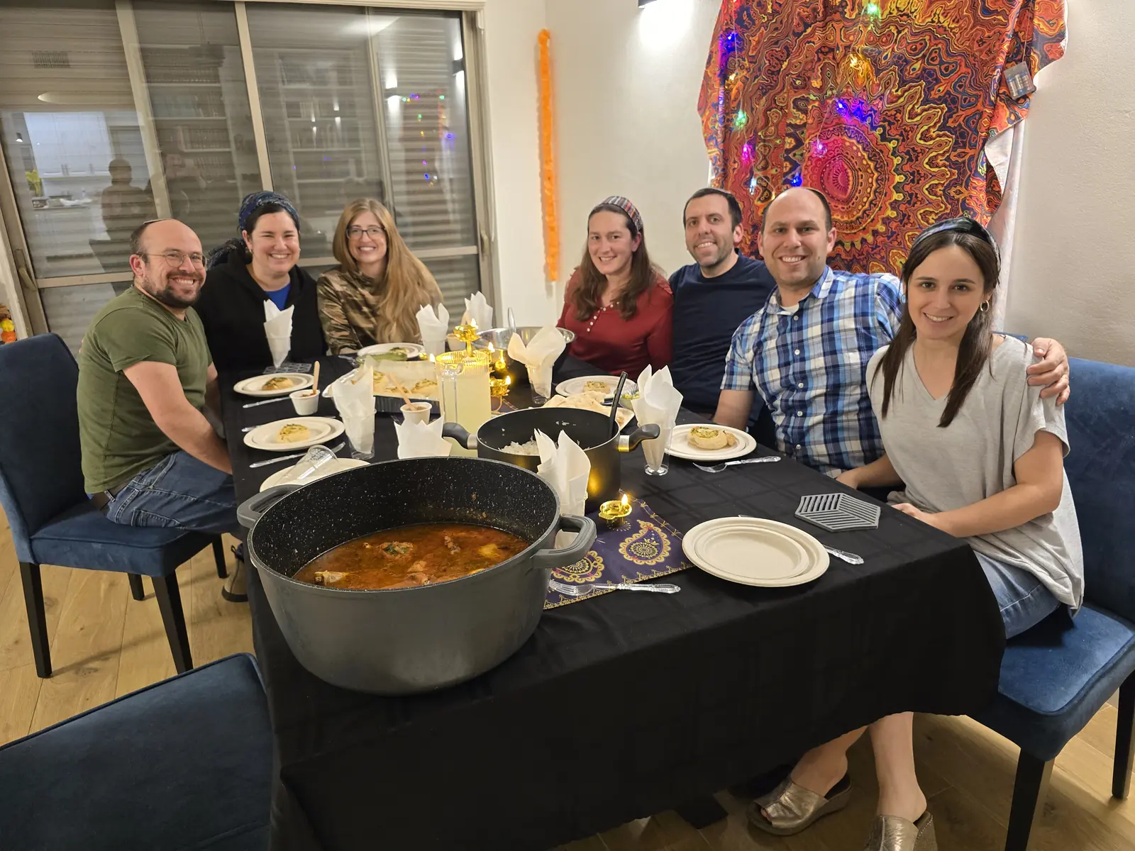 Guests smiling around a private Indian dinner table