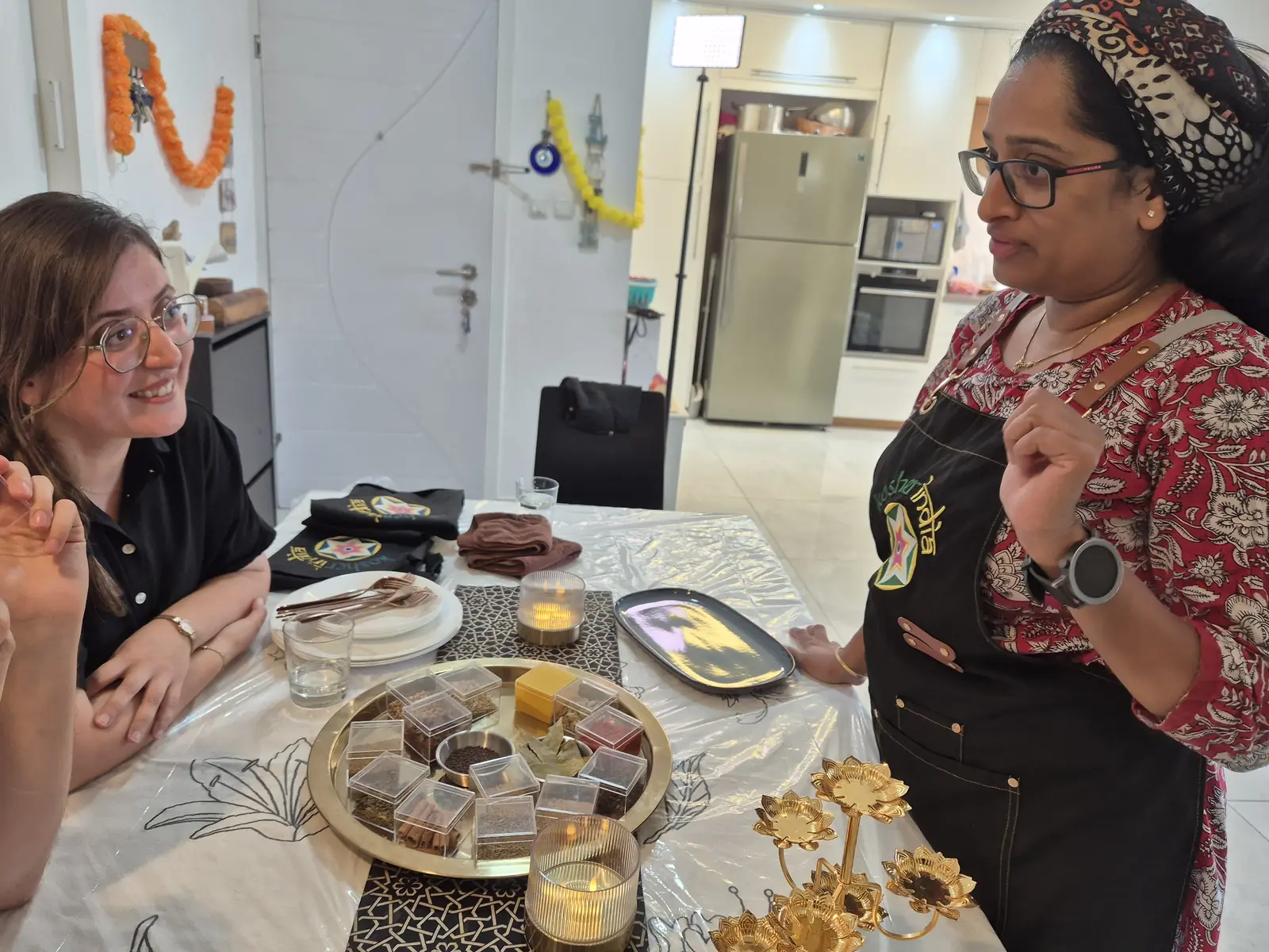 Leron explaining the spices to a guest