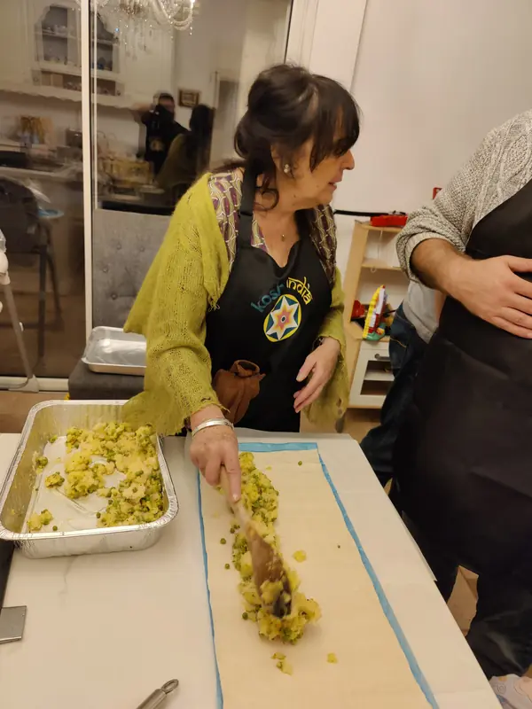 A guest rolling samosa pinwheels