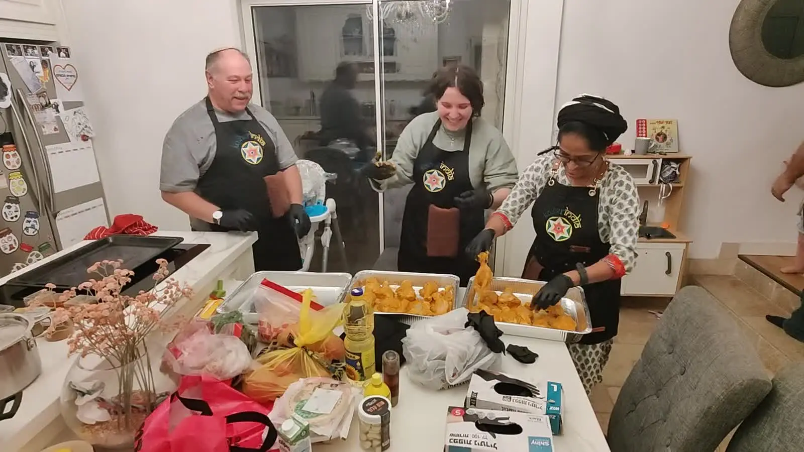 Guests laughing behind the samosas they made at a Kosher India workshop